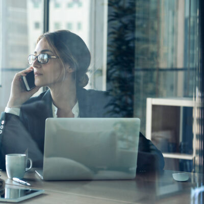 Businesswoman,Talking,On,Cell,Phone,In,Office
